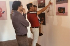 Yangon-exhbition-man-and-son-talking-about-JCSDO-artwork-on-gender-inequalities-in-politics-in-Myanmar